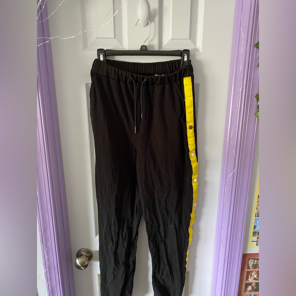 Woman’s small black and yellow side button joggers